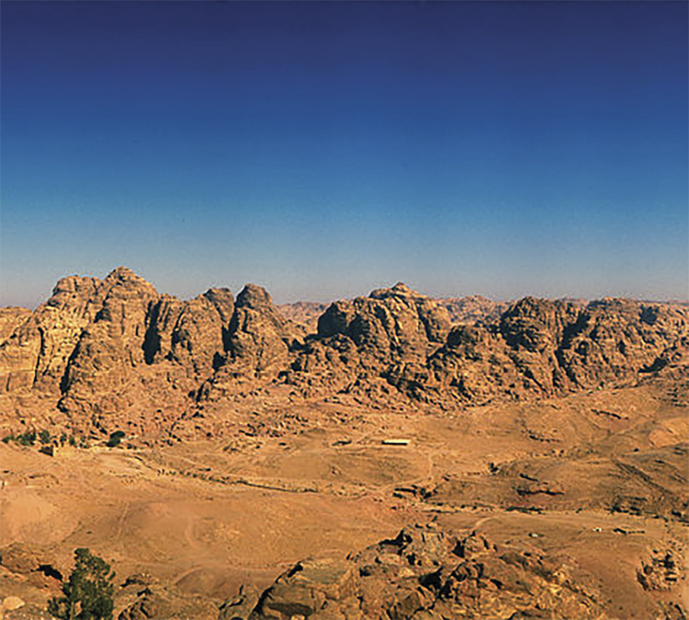 View of Petra in the southeast region of Edom. This is what the Lord God has said about Edom: “Your arrogant heart has deceived you, you who live in clefts of the rock in your home on the heights, who say to yourself, ‘Who can bring me down to the ground?’ Though you seem to soar like an eagle and make your nest among the stars, even from there I will bring you down.” This is the Lord’s declaration.