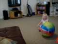 chloe trying to ride a bouncy ball 