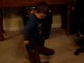 Caleb wearing daddy's boots 