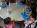 Kids Sitting Down By the Table 