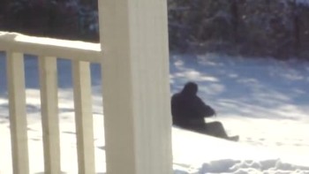 Fat man trying to sled down hill 