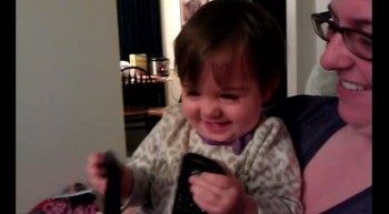 Baby with TV remotes - contagious laughter! 