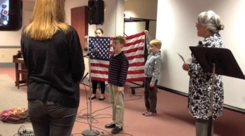 James leads the Pledge of Allegiance then sings the National Anthem at the homeschool group closing program.