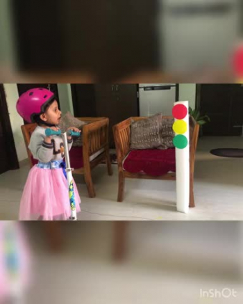 A 4-year-old small girl. Going to explain the traffic light rules to children and their parents around here so that they can understand it in their own language and start following the rules as she describes it in a very good manner and her voice is so clear she tells about three different color.