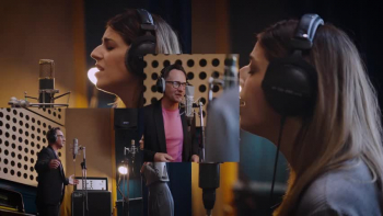 <p>Brooke Ligertwood is joined by <a href="https://www.worshiptogether.com/worship-leaders/martin-smith/">Martin Smith</a> in this official music video of &ldquo;Lead Me To The Cross,&rdquo; and the pair deliver an encouraging, soothing, and stirring reminder that joy is found only through connection with Christ.</p>

<p>In the process of sharing their message, Brooke and Martin also share an inside look at a day in the life of Christian music recording artists. A singer, songwriter, worship leader, and producer,&nbsp; Brooke is the writer of &ldquo;Lead Me To The Cross,&rdquo; as well as so many other faith-filled songs.&nbsp;</p>

<p>She is originally from New Zealand. Born in England, Martin Smith is a Christian singer, songwriter, guitarist, producer, and frontman for the group Delirious?, which performed together from 1992-2009 and was formerly known as <a href="https://en.wikipedia.org/wiki/Delirious%3F">The Cutting Edge Band</a>.&nbsp;</p>

<p>The video begins as the two are greeted and enter a building with bottled water, papers, phones, and bags in their hands. Soon, we are taken into the recording space where Brooke and Martin stand opposite one another in front of microphones; lighting, speakers, drapes, and rose-colored carpet set the acoustic stage. They chat, laugh, and mentally prepare until the musical magic begins at .30.&nbsp;</p>

<p>Dressed in a dark suit and a pink t-shirt, Martin calmly conveys the first perfect words, &ldquo;Savior, I come.&rdquo; He smiles and raises his hands at times, singing with absolute contentment about redemption and ransom as Brooke prepares to join in at 1:55. She is dressed in gray and closes her eyes as she looks up and sings. Her innermost desire is to be brought more closely to Jesus&mdash;led to the cross.&nbsp;</p>

<p><a href="https://www.azlyrics.com/lyrics/hillsongunited/leadmetothecross.html">Here are four lines</a> from the &ldquo;Lead Me To The Cross:&rdquo;</p>

<p>Lead me to the cross<br />
Where Your love poured out<br />
Bring me to my knees<br />
Lord, I lay me down</p>

<p>The video is often framed by a rather formal, floral wallpaper, and periodically, flashes of Brooke and Martin side-by-side or individually pop in multiples onto the screen. It seems like a combination of modern and old-fashioned elements, and the result is visibly pleasing&mdash;pretty and joyful.&nbsp;</p>

<p>And, joyful is exactly how the singers appear when they pick up the tempo slightly and begin to finish the song at 3:15. Their smiles express the delight in their hearts!</p>

<p>As the song draws to a close, we see Brooke and Martin leave the studio and return to the streets. They walk quickly and discuss the work of the day, and when the camera pans out to show the entire cityscape, we see in view a beautiful ocean&hellip;and a tall, white, beautiful cross.</p>

<p><em>&ldquo;Those who belong to Christ Jesus have nailed the passions and desires of their sinful nature to his cross and crucified them there.&rdquo; <a href="https://www.godtube.com/bible/galatians/5-24">Galatians 5:24</a></em></p>
