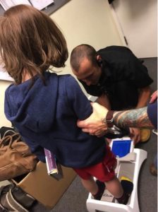 godupdates employee calms boy with autism shoe shopping with mom 3