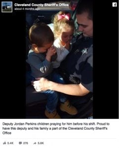 godupdates photo of kids praying for police officer dad 1