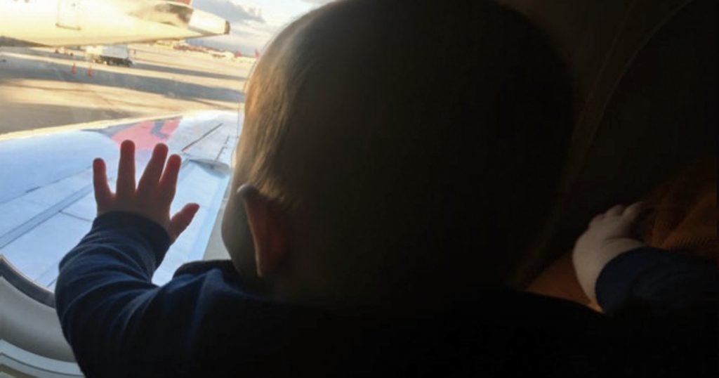 godupdates stranger held an exhausted dad's son on plane fb