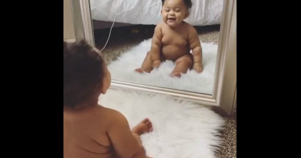 godupdates beautiful baby girl stares at herself