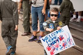 toddler holds up sign for dad